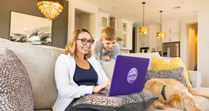 GCU Online Student Female GCU student stying online next to child at their home