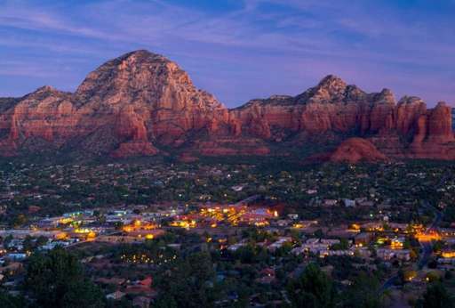 Scenic landscape view of red rock formations under a twilight sky
