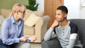 biracial youth speaking to a therapist