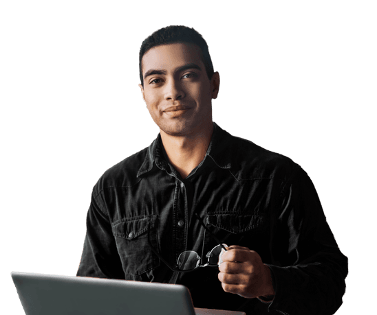 Young and happy male sits in front of his laptop smiling 