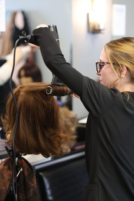 Cosmetology student styling hair