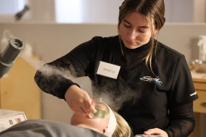 Esthetics student performing a facial