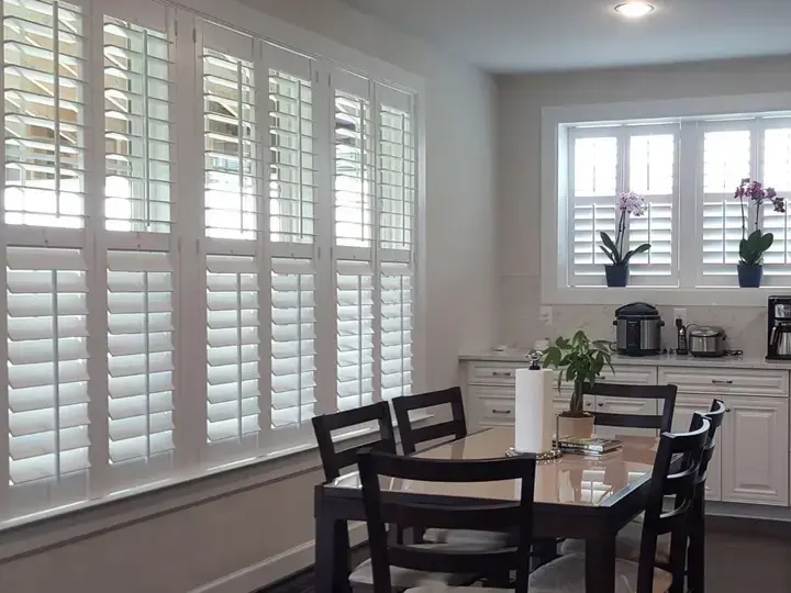 White plantation shutters in a bright dining room
