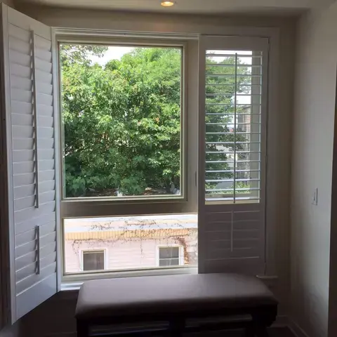 Plantation shutters opened on a window seat