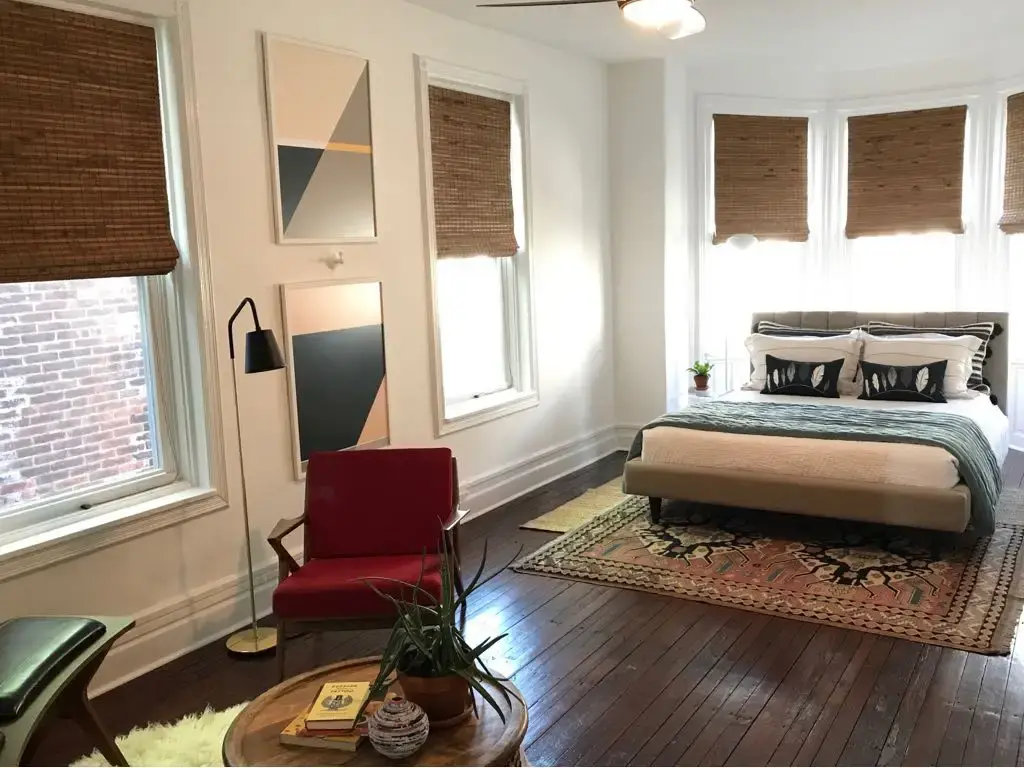 Woven wood shades in a bedroom bay window