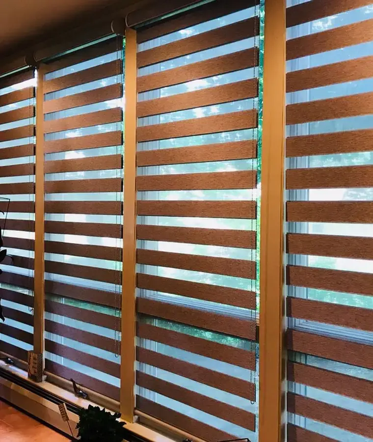 Banded shades across a wall of windows