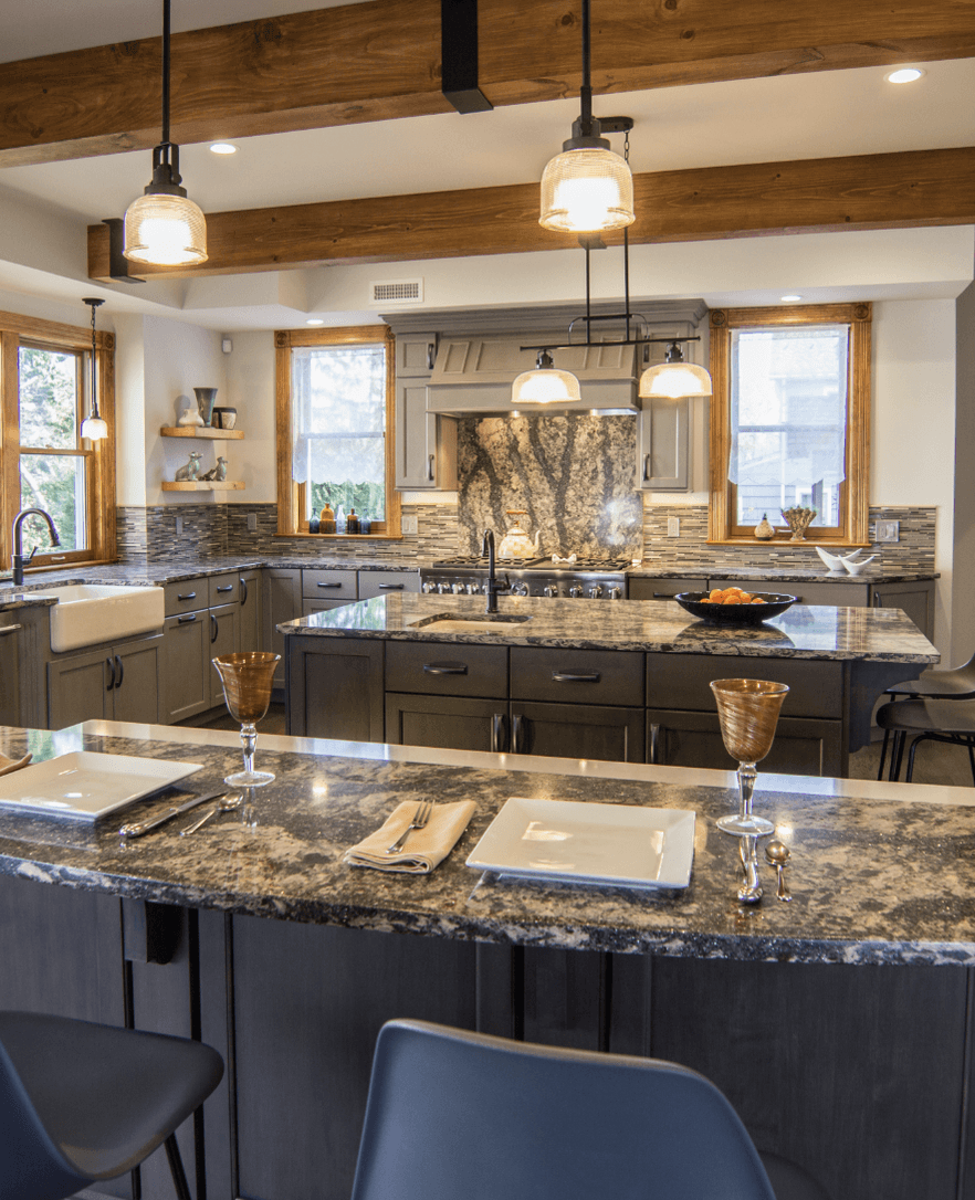 Granite kitchen islands and full-height granite backsplash by Marble Concepts