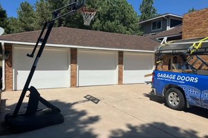 Triple white garage doors installed