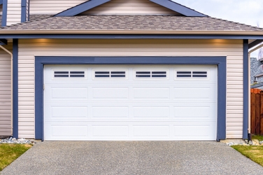 Grey garage door with windows at the top