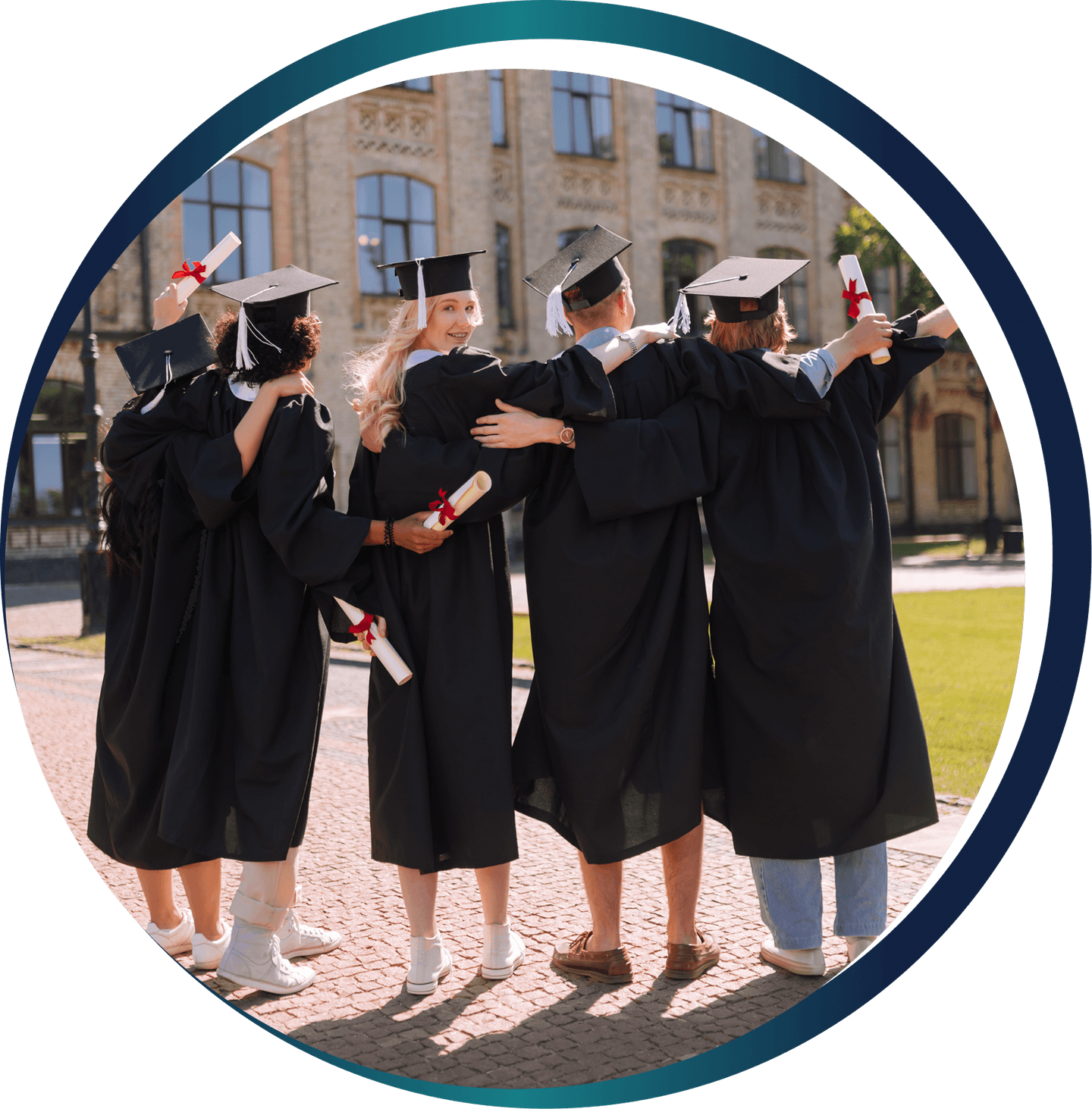 Graduates in academic regalia facing a university building