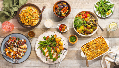 Various healthy dishes spread out on a wooden table.