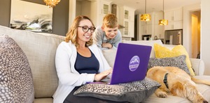 Female GCU student stying online next to child at their home