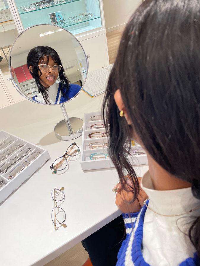 Patient checking new frames in the mirror