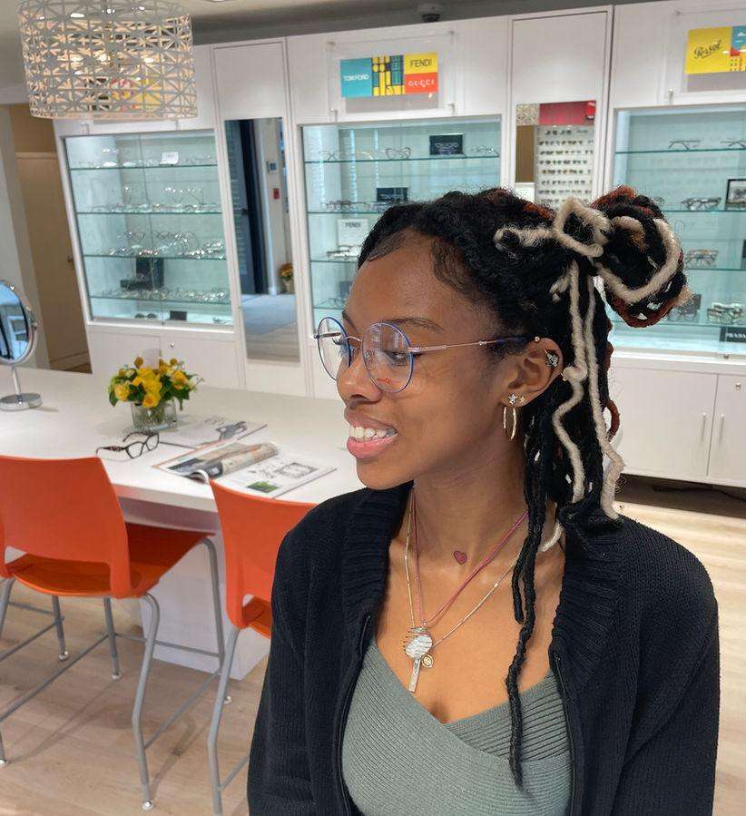 Customer trying on glasses at Shades Providence