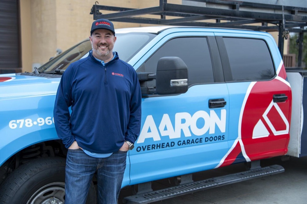 Bingo Garage Doors technician next to his service truck