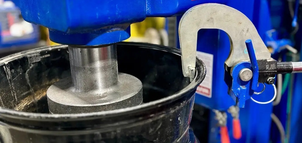 Close-up of a wheel on the rim-straightening machine at Green Tires