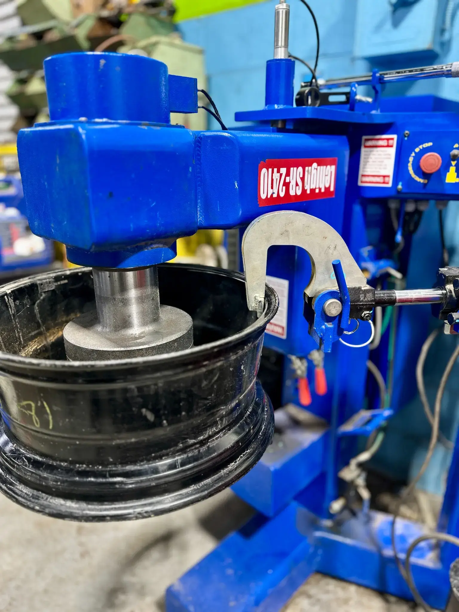 A wheel on the in-house rim straightening machine at Green Tires