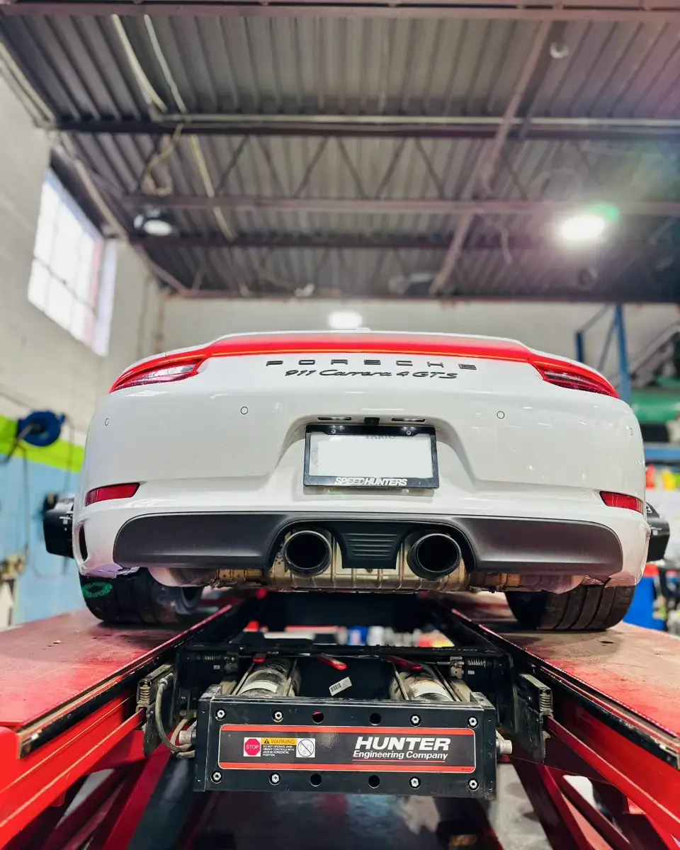 Porsche in the Green Tires shop on a Hunter alignment rack