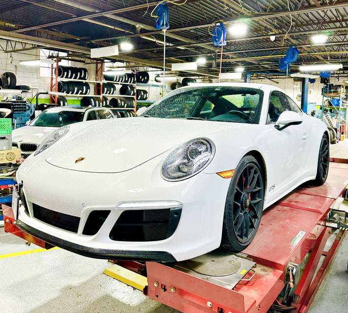 White Porsche on the wheel-alignment lift at Green Tires in Scarborough