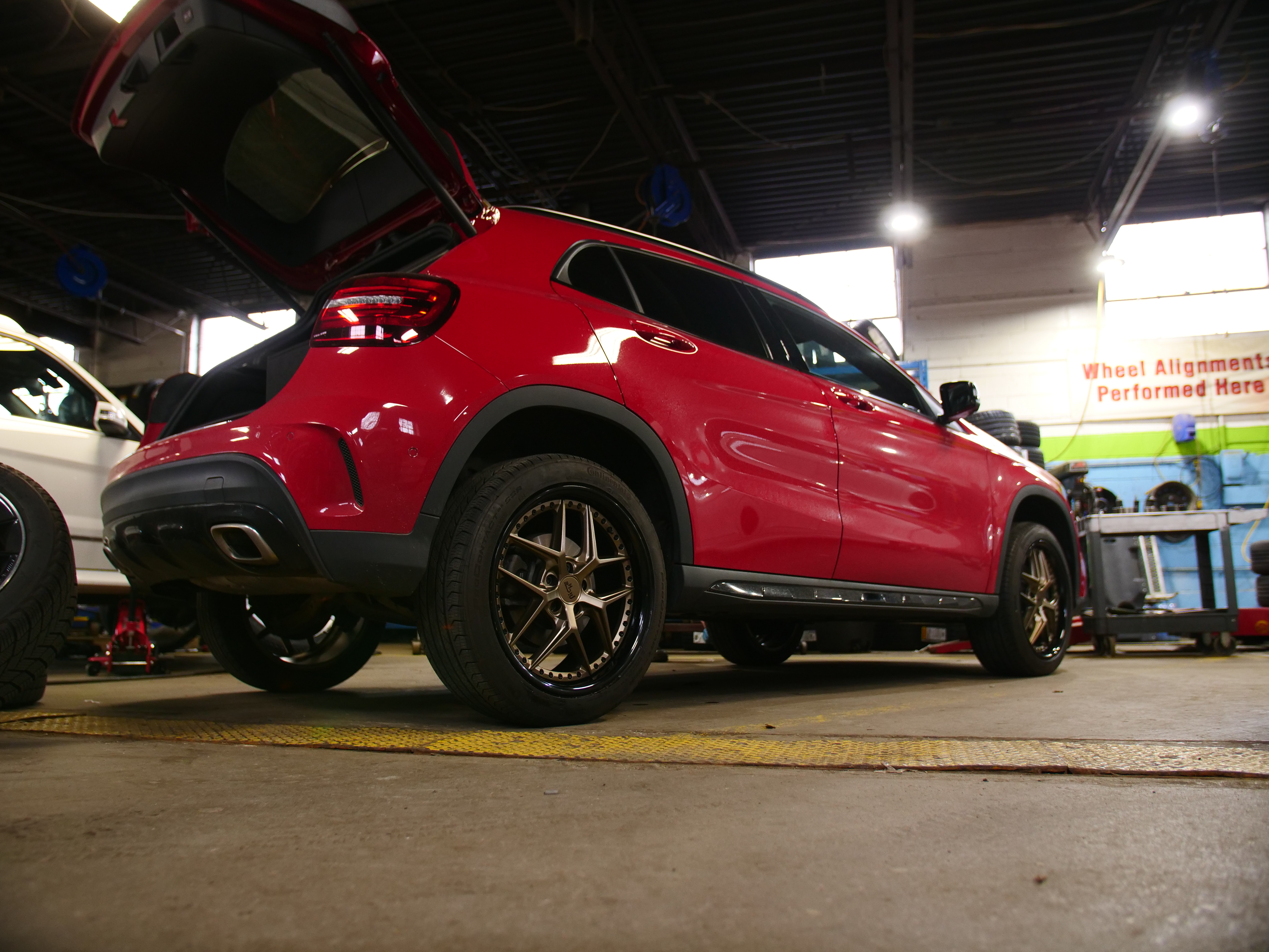 Red SUV photographed in the Green Car Tires shop