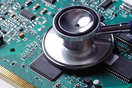a stethoscope rests on top of a medical device chip board