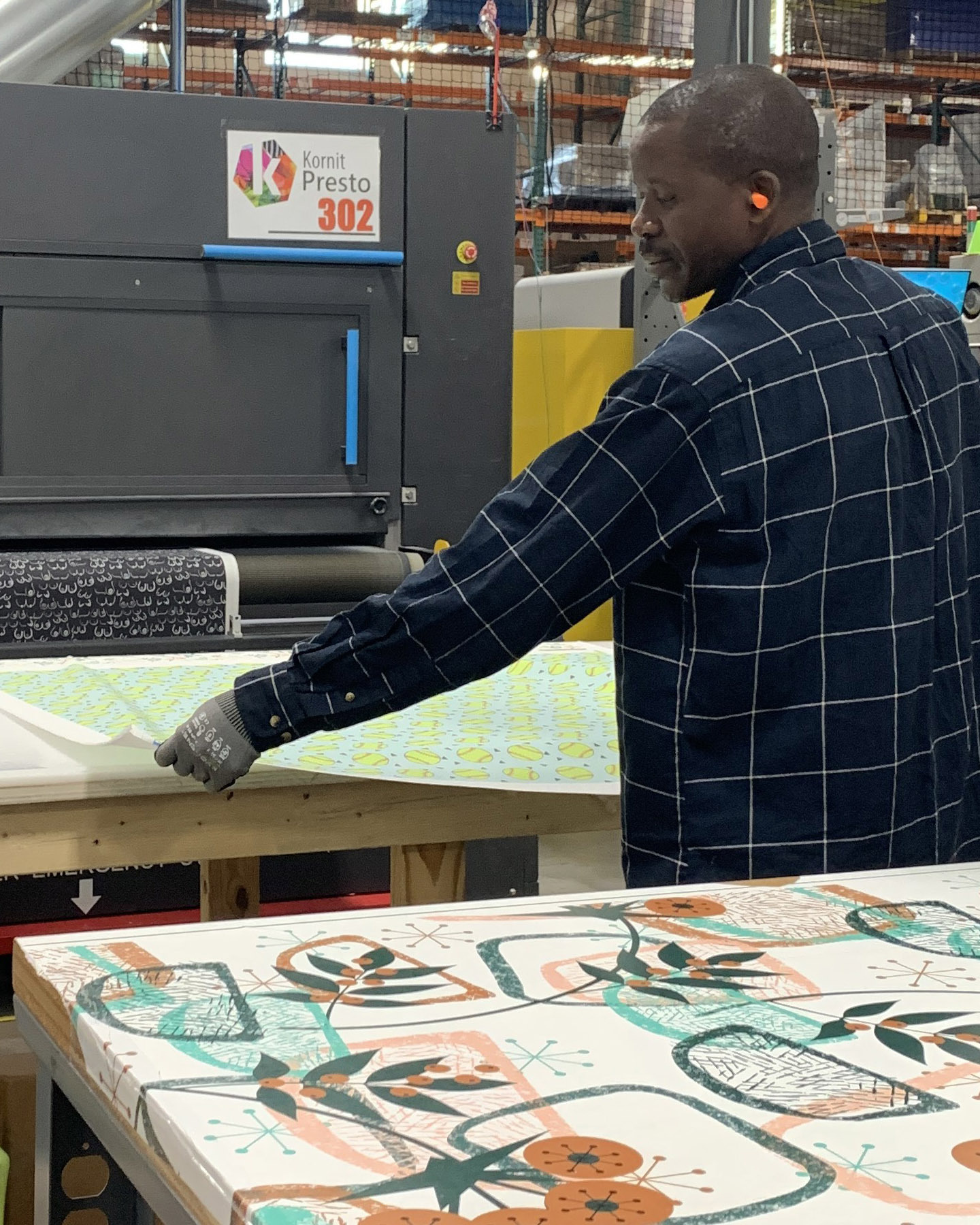 Person inspecting fabric in manufacturing facility