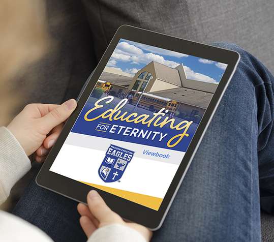 Image of woman holding an iPad and reading the e-book.