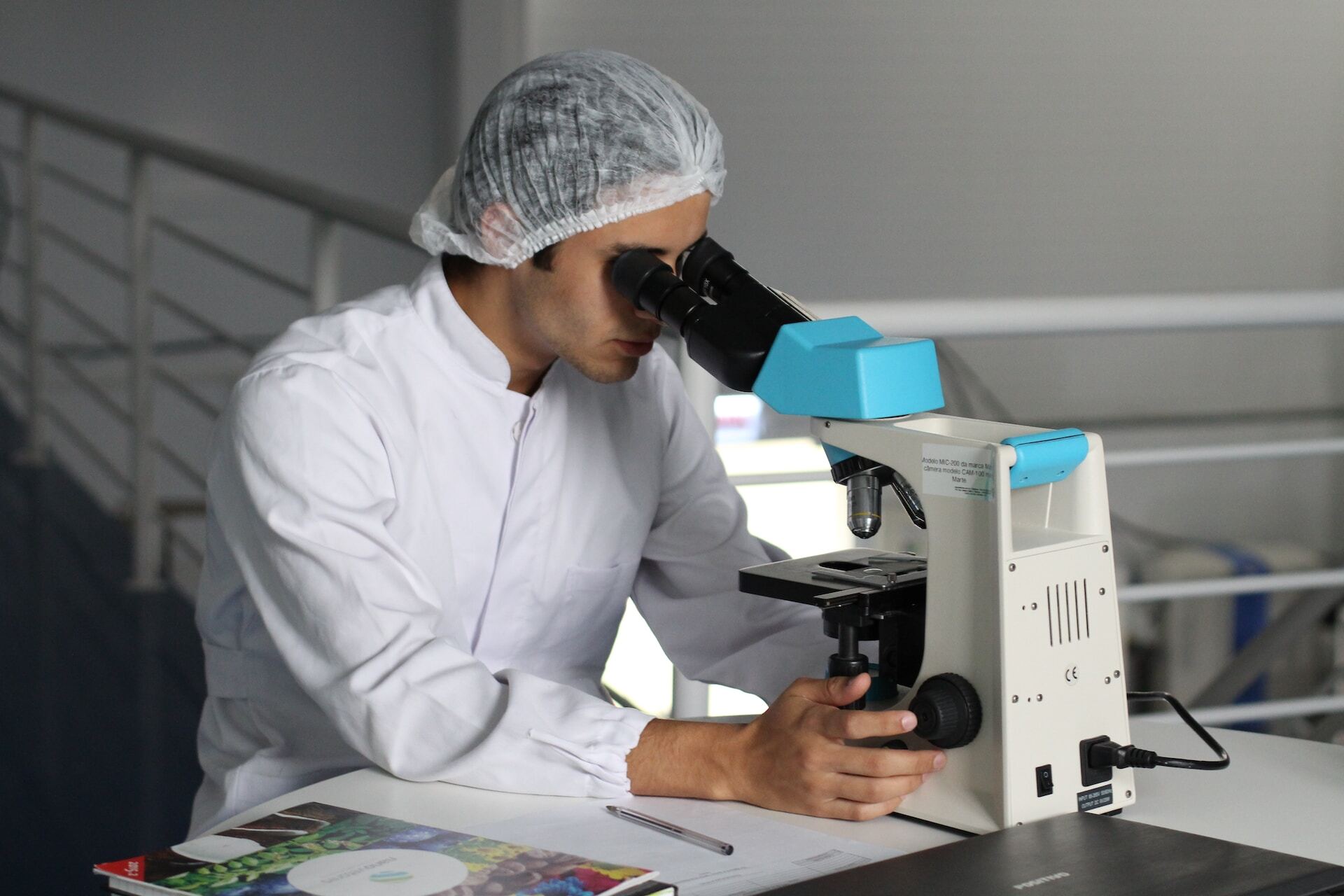 researcher looking through microscope