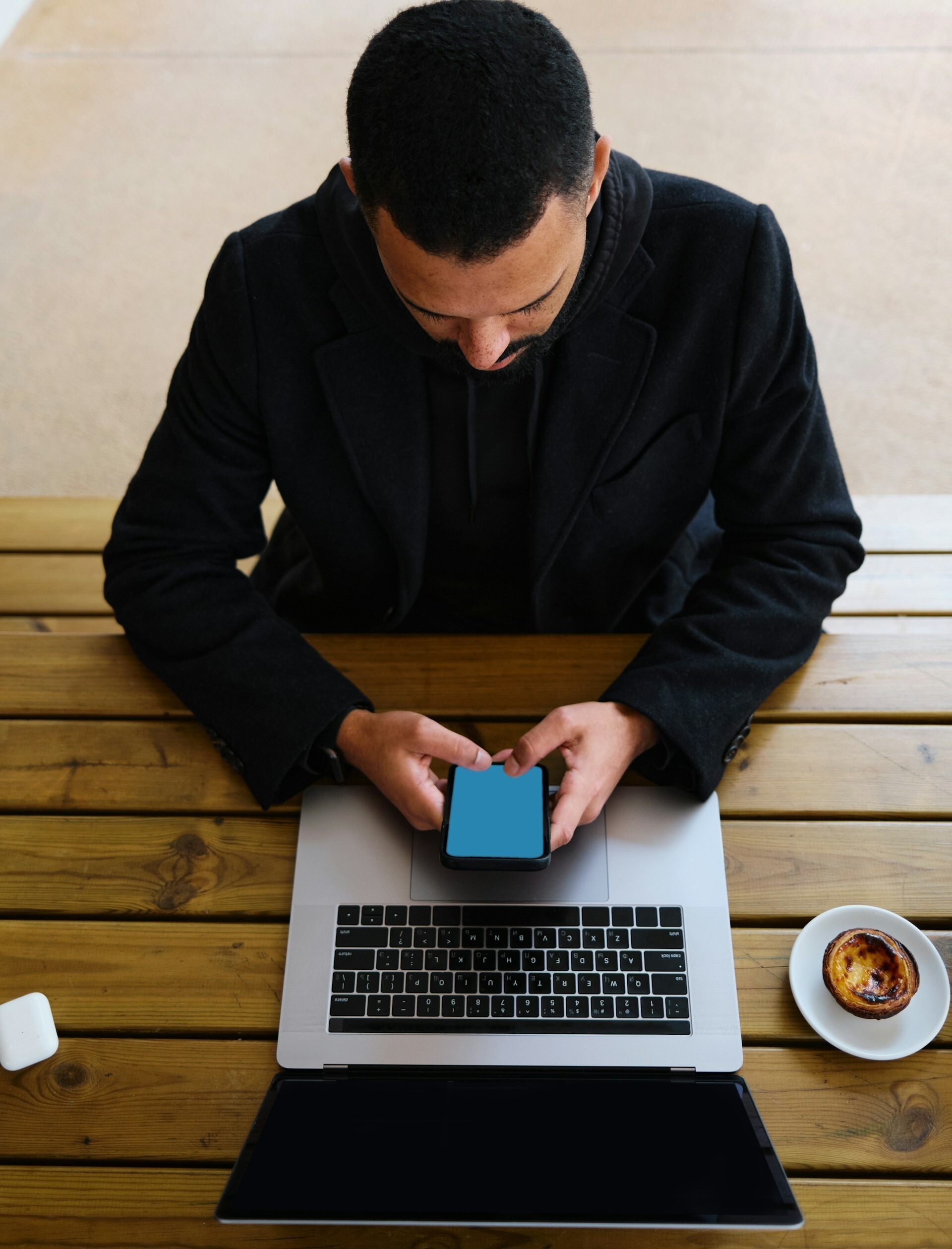 man working on laptop and cellphone