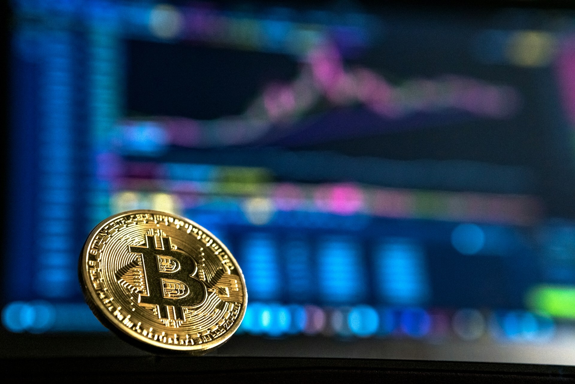 Bitcoin in front of a graph on computer screen