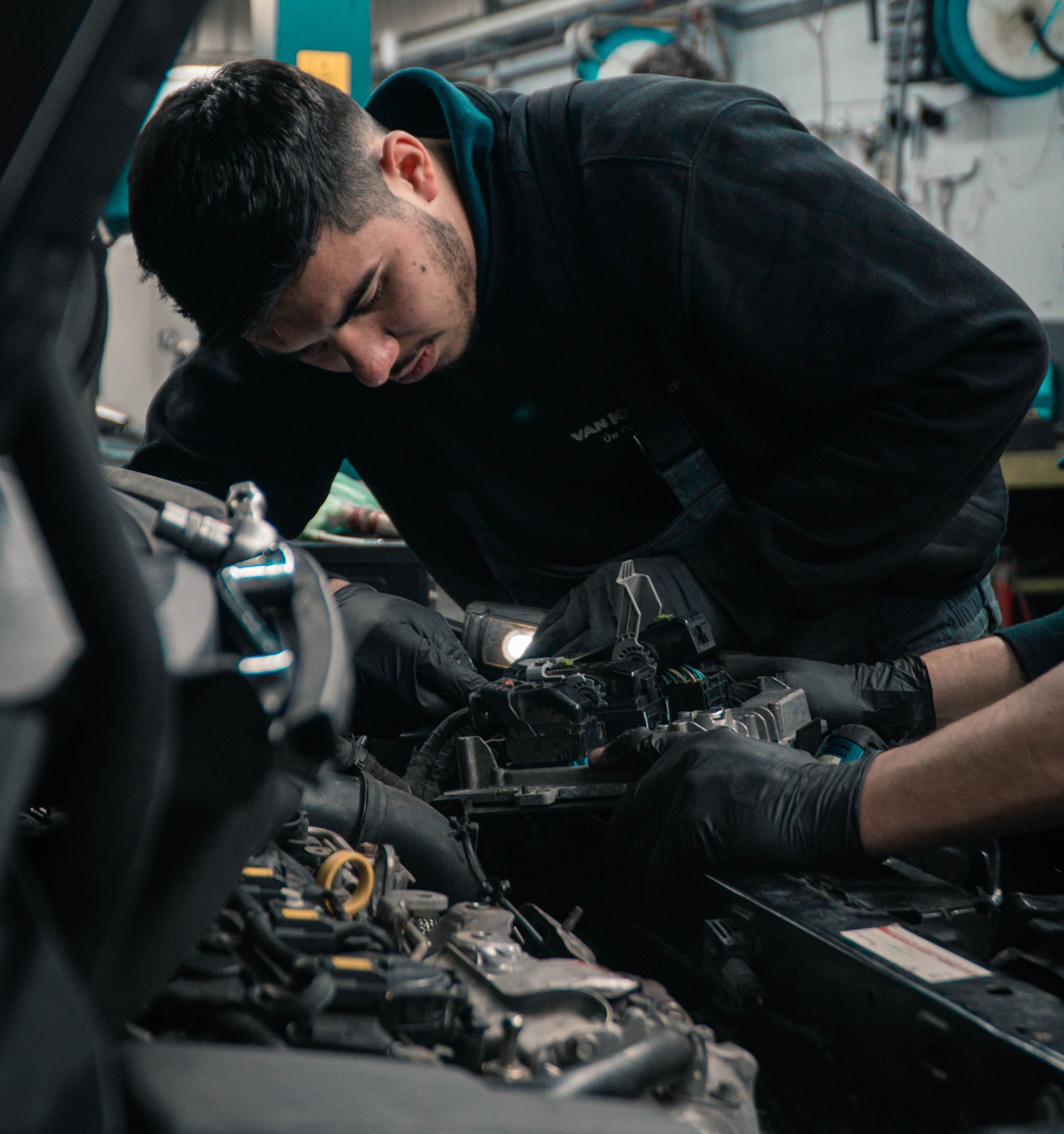 mechanic working on car engine