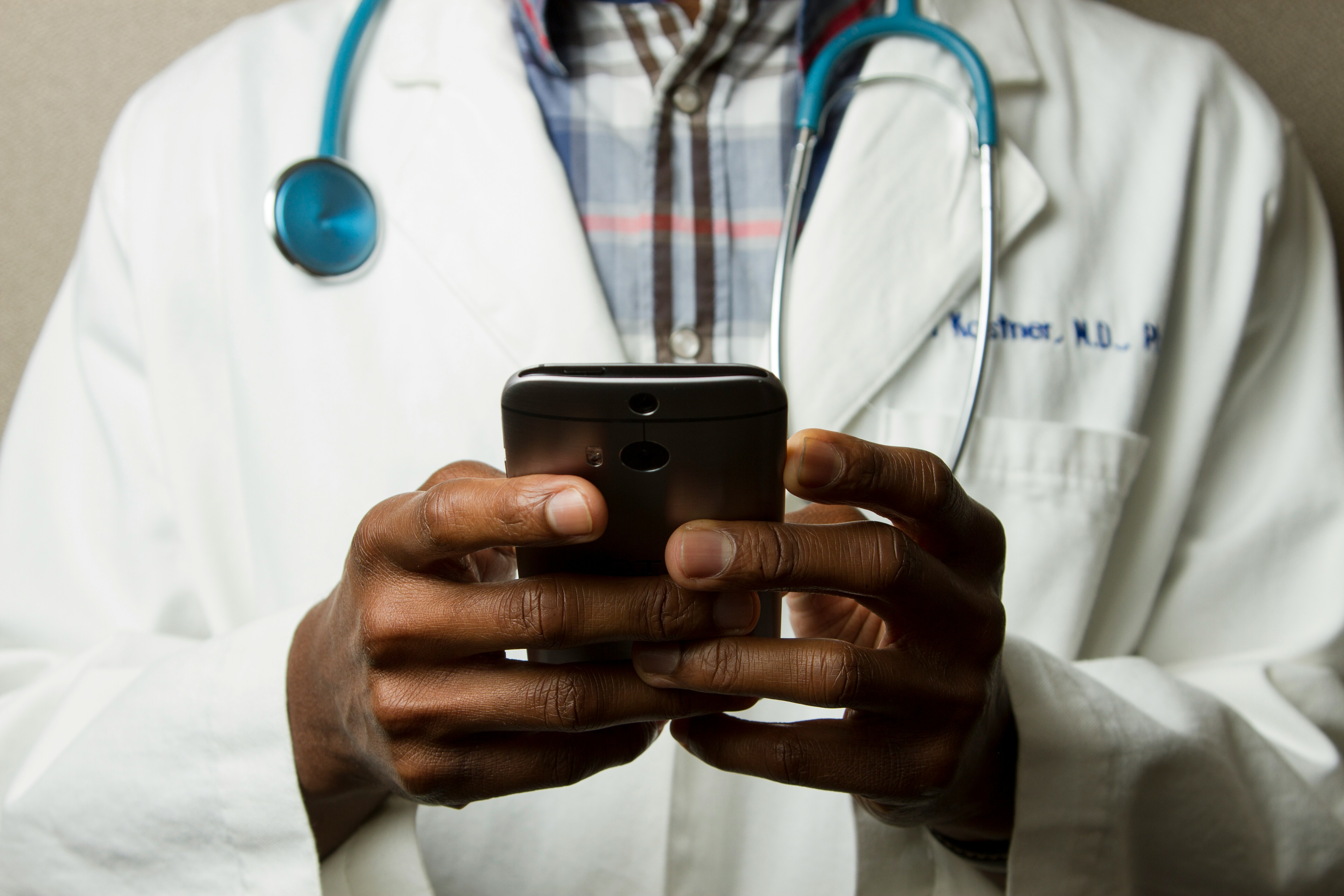 doctor looking at phone