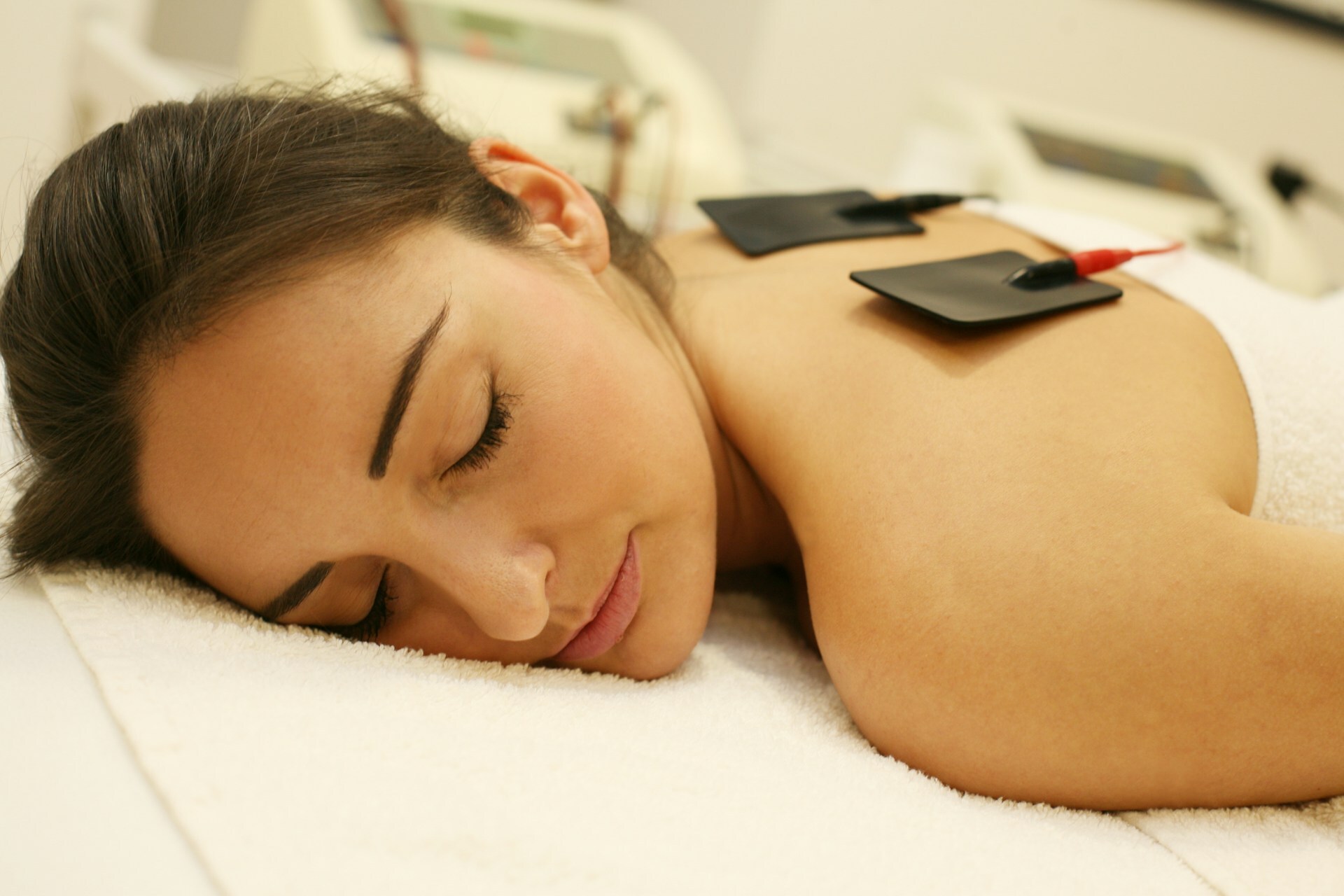 woman wearing electrotherapy medical device