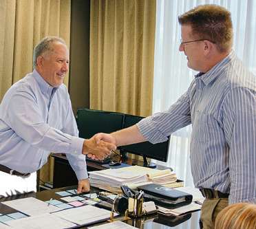 Siegfried and Jensen founders with happy client 