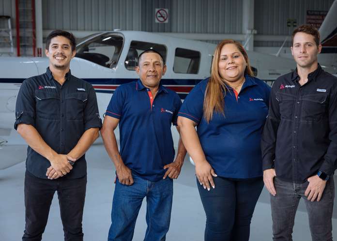 Skytropic team standing in front of an aircraft