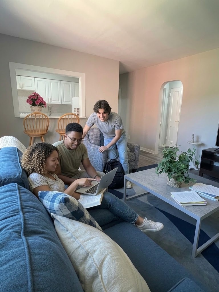 Residents studying together in a Meadow Lane Apartments living room