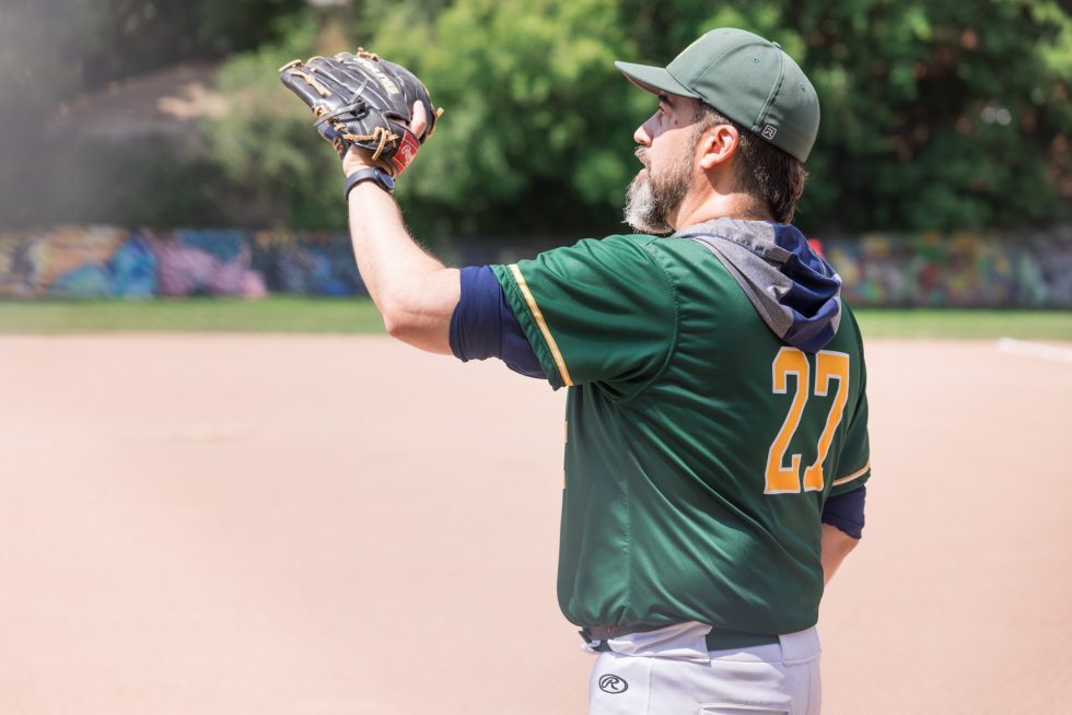 Coach Ryan Freeman leading an on-field baseball warm-up