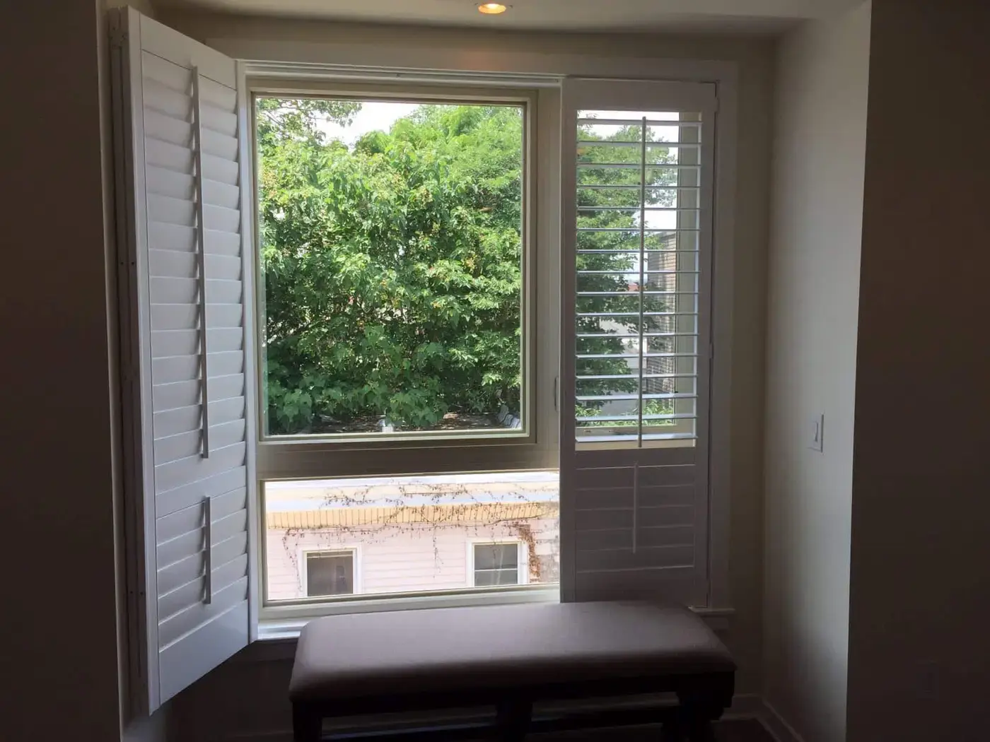 Plantation shutters opened on a window seat
