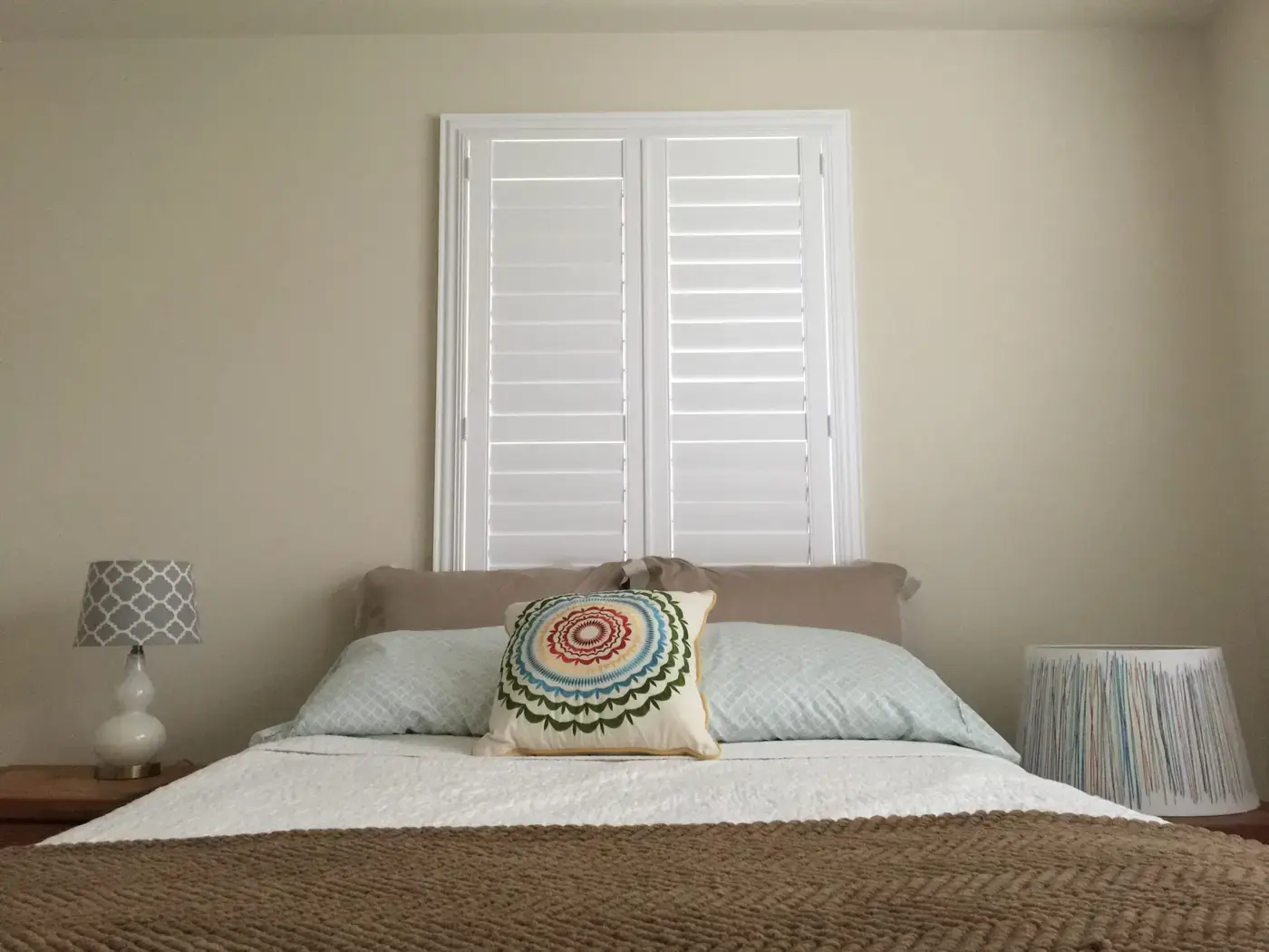White shutters above a bed
