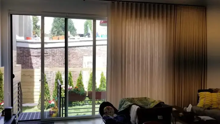 Floor-to-ceiling draperies beside a sliding door