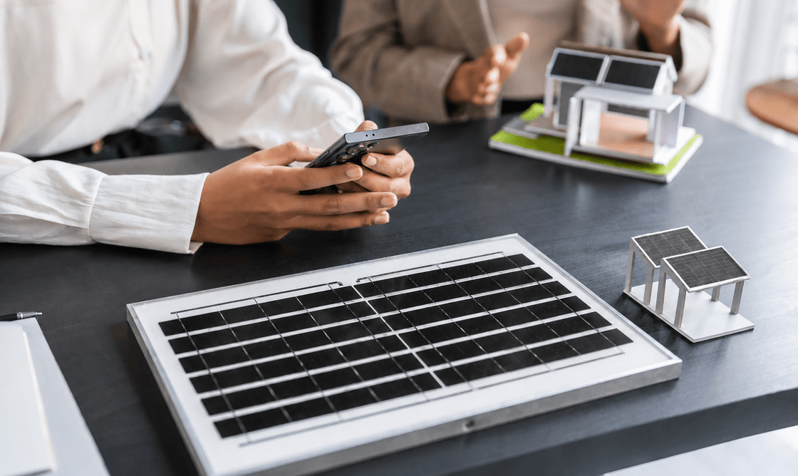 Family reviewing solar plans with installer