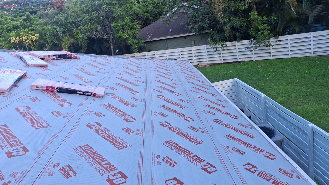 Professional roofing team installing a total roof replacement
