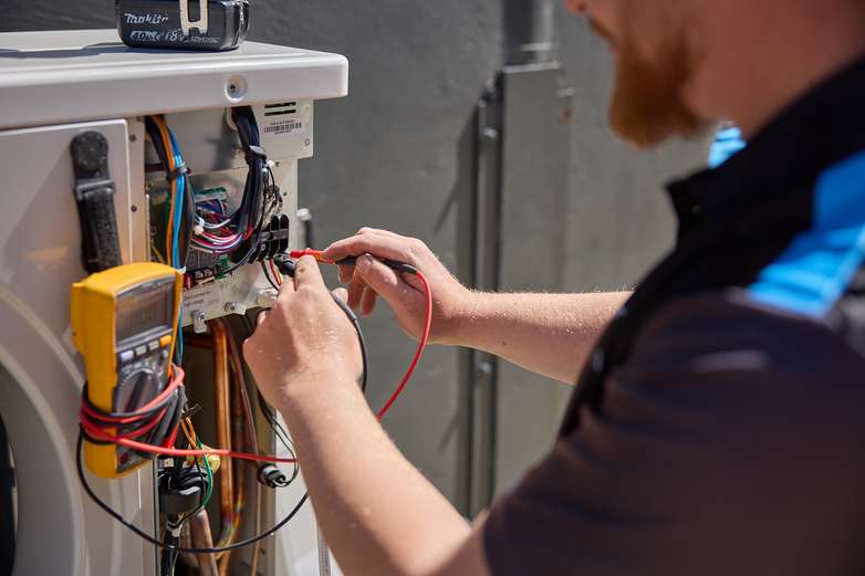 Technician testing an air conditioning system