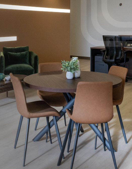 Coffee table with multiple chairs surrounding, in lounge-type area