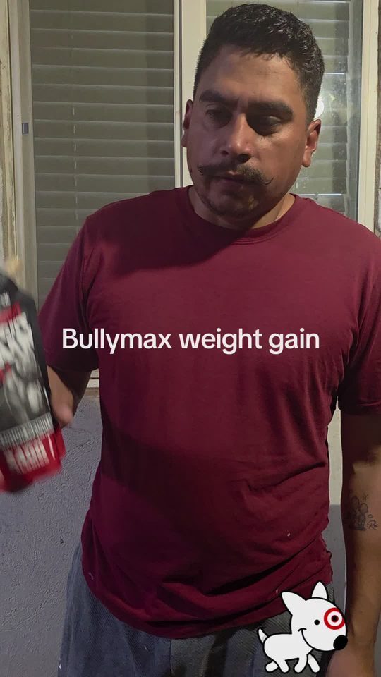 Dog owner in a red shirt talking to camera about Bully Max