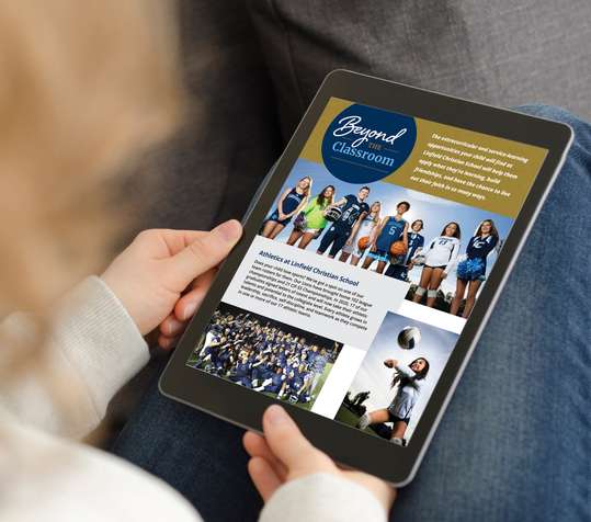 Image of woman holding an iPad and reading the e-book.