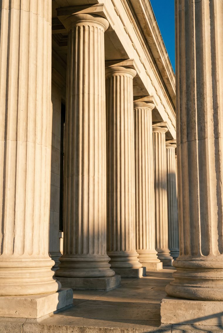 Limestone columns of a bank building in morning light