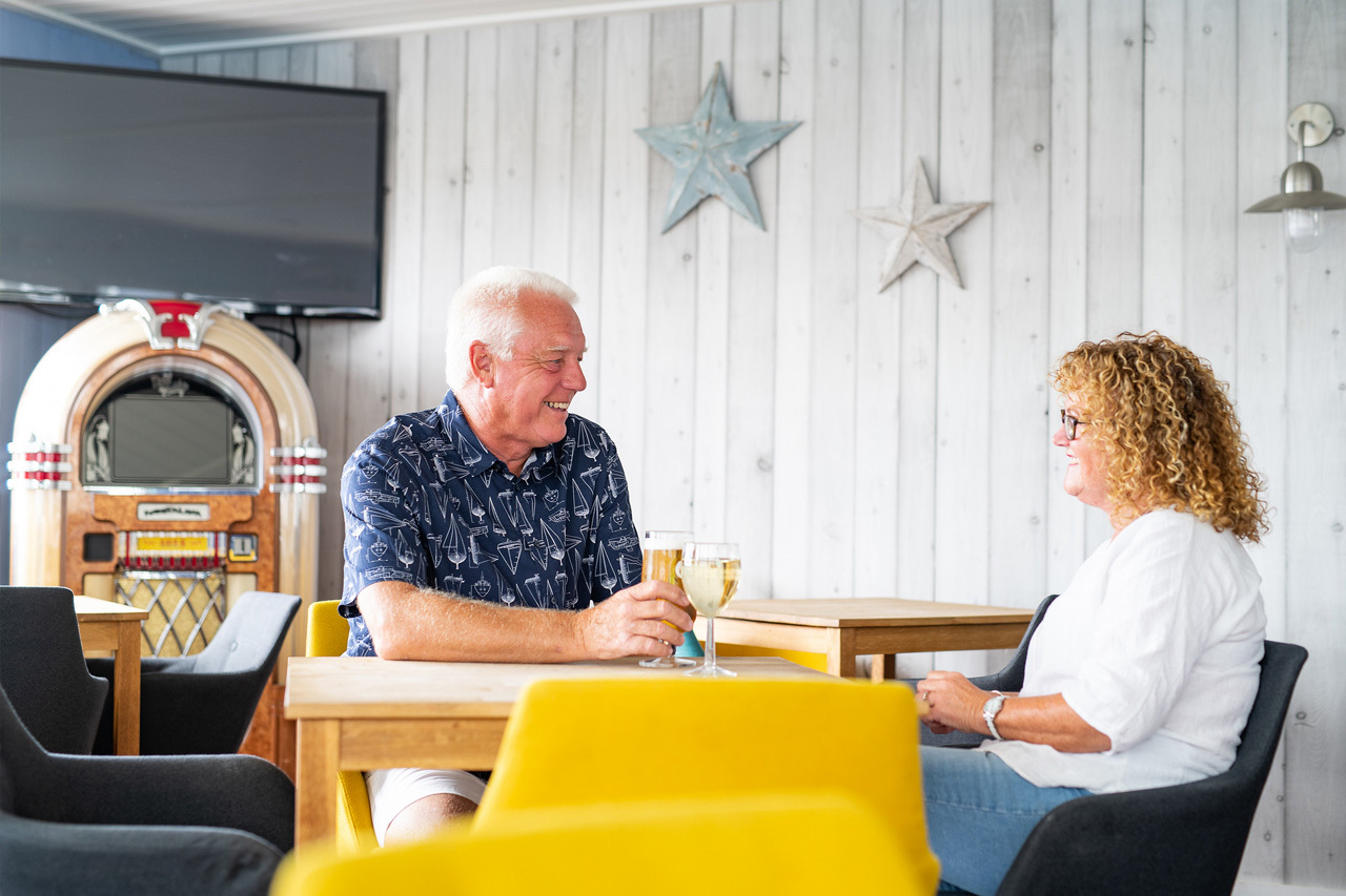 Couple enjoying a drink in the bar at Mersea Island.