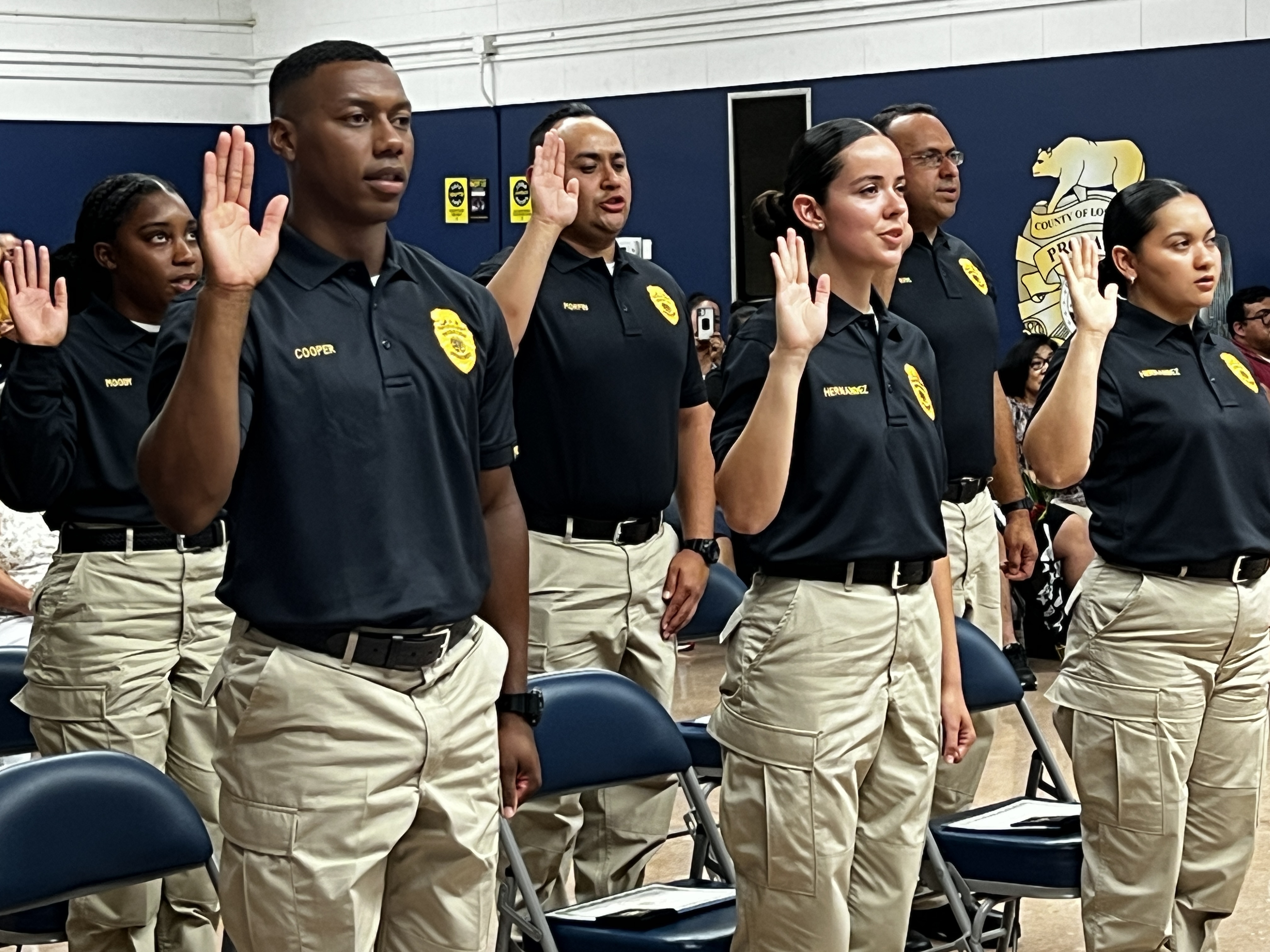 A class of LACP officers raising their right hand at ceremony