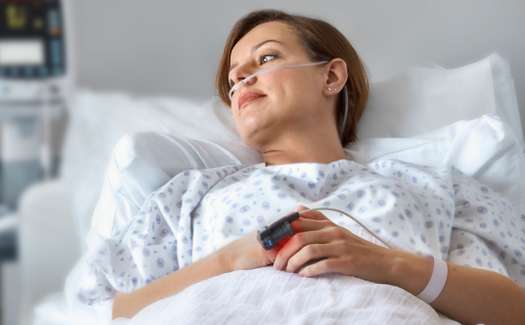 9853c254-woman-in-hospital-bed-with-sensor-and-cannula_10lg0g80el09106v04k01o.jpg